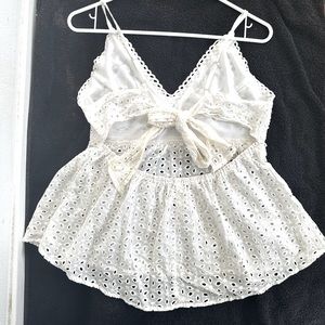 Women spaghetti top with open back.  With a back bowtie. Color white.